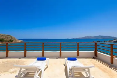 a balcony with chairs and a view of the ocean at Haraki Sea View Luxury House in Rhodes Town