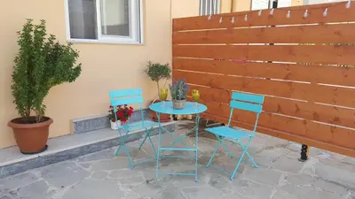 a table and two chairs sitting next to a fence at Maximos Sea & The City in Rhodes Town