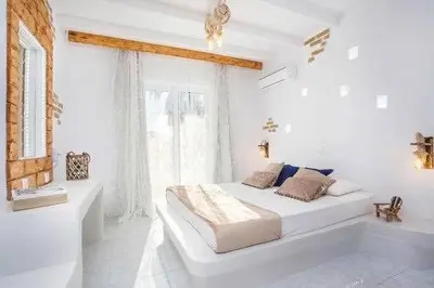 a white bedroom with a bed and a bath tub at Faliraki Blue Villas in Faliraki