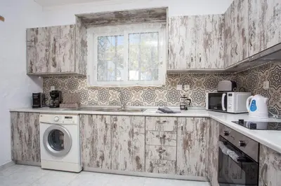 a kitchen with a sink and a washing machine at Faliraki Blue Villas in Faliraki