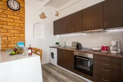 a kitchen with a counter and a clock on the wall at Faliraki Blue Villas in Faliraki