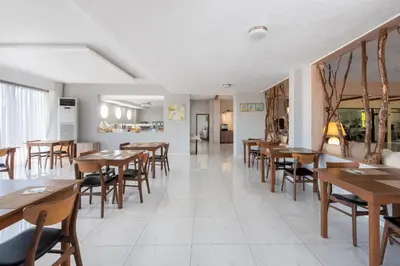 a dining room with wooden tables and chairs at Afandou Blu in Afantou