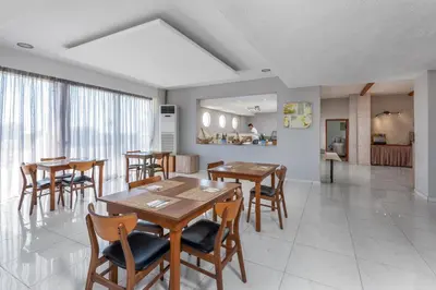 a dining room with wooden tables and chairs at Afandou Blu in Afantou