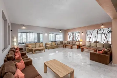 a large living room with couches and tables and windows at Afandou Blu in Afantou