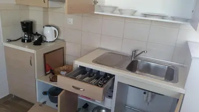 a small kitchen with a sink and a counter at Ria's Deluxe Apartments in Faliraki
