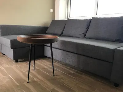 a living room with a couch and a wooden table at Ria's Deluxe Apartments in Faliraki