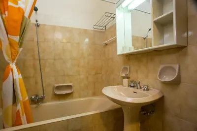 a bathroom with a sink and a bath tub at Muses Hotel in Faliraki