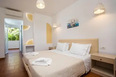 a bedroom with a bed with two towels on it at Muses Hotel in Faliraki