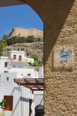 a building with a sign on the side of it at Thea Villas and Suite in Líndos