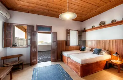 a bedroom with a bed and a wooden ceiling at Thea Villas and Suite in Líndos