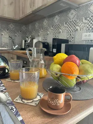 a kitchen counter with a bowl of fruit and a bowl of oranges at New Lindos Studio 45 renovated in Líndos