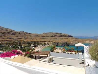 a view from the roof of a resort with a beach at New Lindos Studio 45 renovated in Líndos