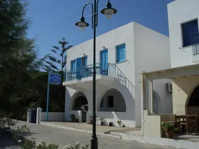 a street light in front of a white building at Kleopatra's Rooms in Livadia