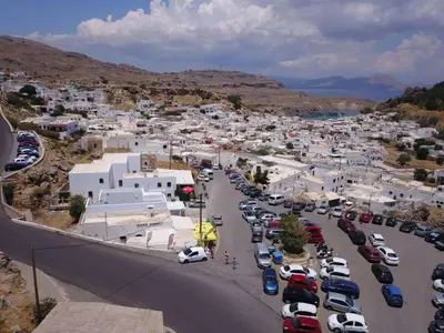an aerial view of a parking lot in a town at Traditional Lindian Suites in Líndos