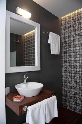 a bathroom with a sink and a mirror and towels at Traditional Lindian Suites in Líndos