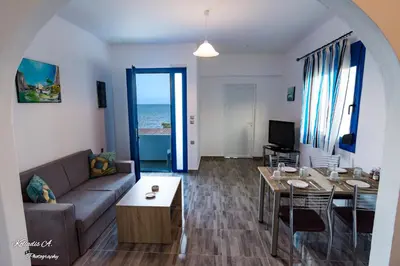 a living room with a couch and a table at Riva Del Mare in Archangelos