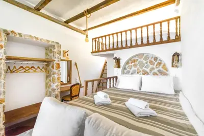 a bedroom with a large bed with white pillows at Limeri Traditional Guest House in Monólithos