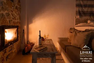 a living room with a couch and a table with wine glasses at Limeri Traditional Guest House in Monólithos