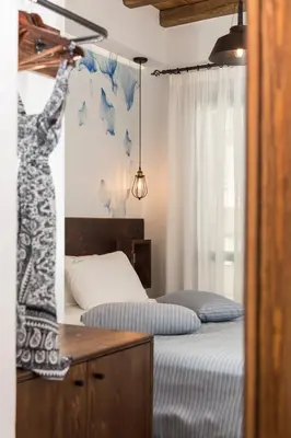 a bedroom with a bed and a desk and a bed at Blue Jasmine Suites in Rhodes Town
