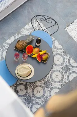 a table with a plate of fruit on it at Blue Jasmine Suites in Rhodes Town