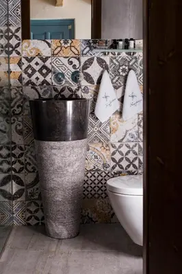 a bathroom with a trash can and a toilet at Blue Jasmine Suites in Rhodes Town