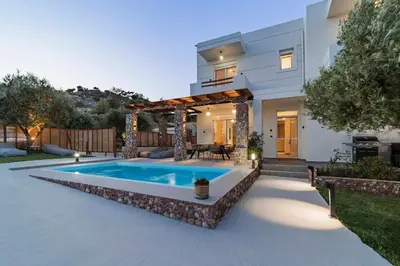 a swimming pool in the backyard of a house at Villa Tranquila Rhodes in Psinthos