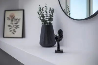 a black vase on a white shelf with a mirror at Villa Tranquila Rhodes in Psinthos