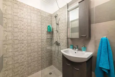 a bathroom with a sink and a shower at Olivia's Sweet Home in Rhodes Town