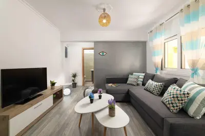 a living room with a couch and a tv at Olivia's Sweet Home in Rhodes Town
