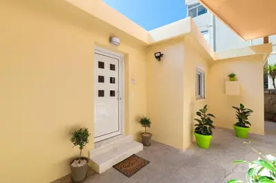 a room with a white door and potted plants at Olivia's Sweet Home in Rhodes Town