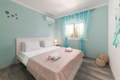 a bedroom with two beds with towels on them at Olivia's Sweet Home in Rhodes Town