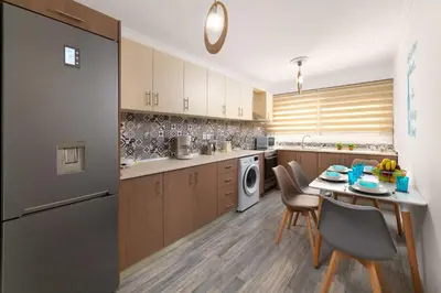 a kitchen with a table and chairs in a kitchen at Olivia's Sweet Home in Rhodes Town
