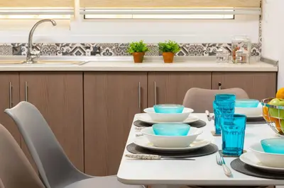 a kitchen with a table with blue dishes on it at Olivia's Sweet Home in Rhodes Town