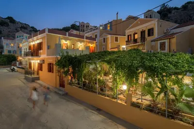 a group of people walking in front of a building at Grace Hotel & Studios in Symi