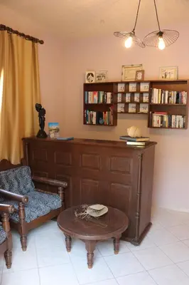 a living room with a desk and a chair and a table at Grace Hotel & Studios in Symi