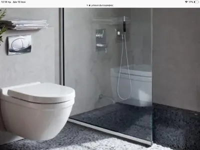 a bathroom with a toilet and a glass shower at Grace Hotel & Studios in Symi