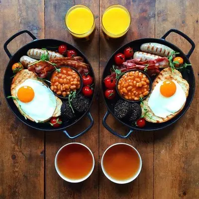 two pans of food with eggs and beans on a table at Captain's Suites in Symi