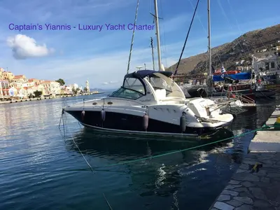 a boat is docked in the water at a dock at Captain's Suites in Symi