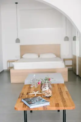 a room with a table with flowers and a bed at Ktima Tzaneti in Lachania