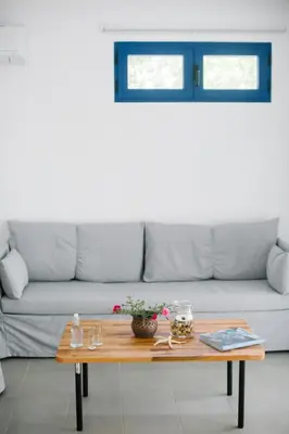 a living room with a couch and a wooden table at Ktima Tzaneti in Lachania