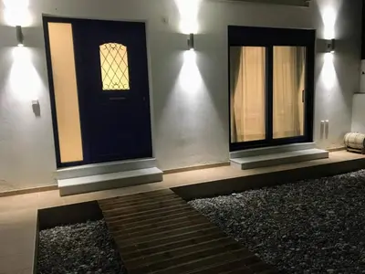 a room with a black door and a window at Ktima Tzaneti in Lachania