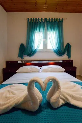 two towels shaped like swans laying on a bed at Villa Fantasea in Plimmiri