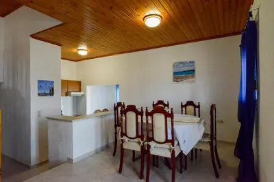 a kitchen with a table and chairs in a room at Villa Fantasea in Plimmiri