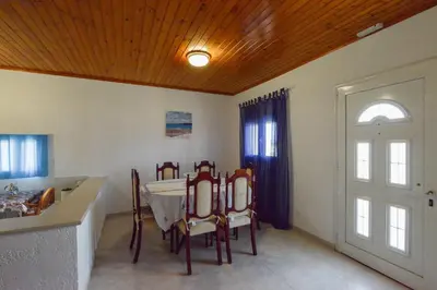 a kitchen with a table and chairs in a room at Villa Fantasea in Plimmiri