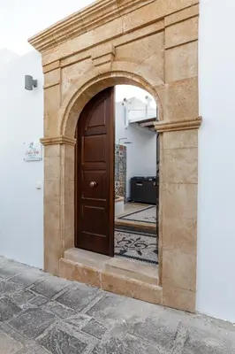 an archway with a wooden door in a building at Lindos Vista Luxury Villa in Líndos
