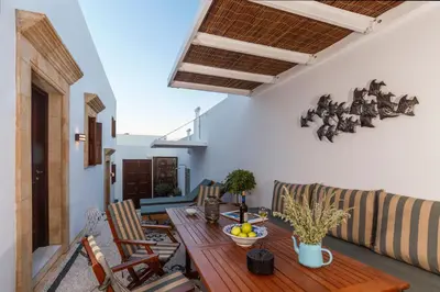 a living room with a table and a couch at Lindos Vista Luxury Villa in Líndos