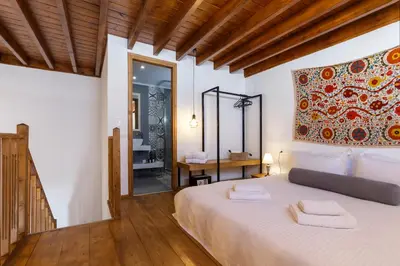 a bedroom with a large bed and a mirror at Lindos Vista Luxury Villa in Líndos