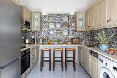 a kitchen with wooden cabinets and bar stools at Lindos Vista Luxury Villa in Líndos