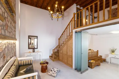 a living room with a couch and a chandelier at Lindos Vista Luxury Villa in Líndos