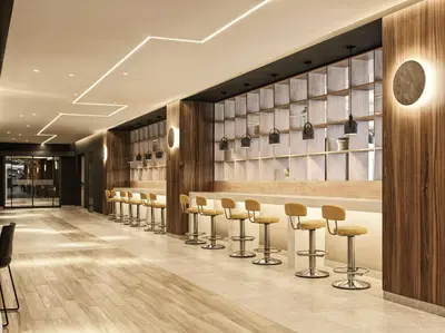 a row of stools in a restaurant with a bar at Esperides Beach Resort in Faliraki